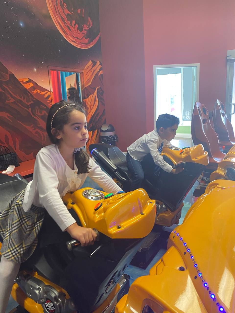 Kids enjoying the arcade rides at Lazer Runner